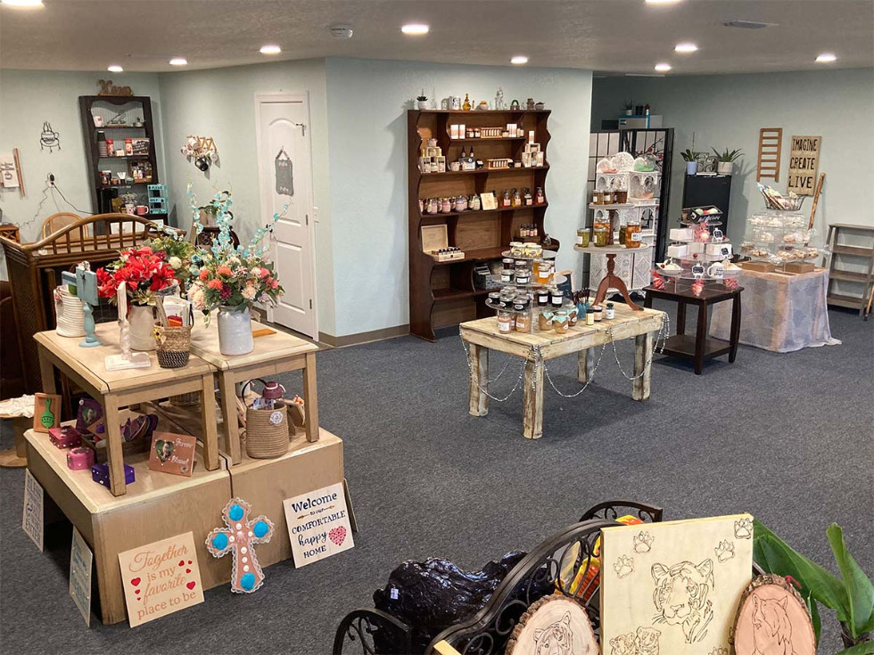 various items on display for sale in the store; flower arrangements, jellies in jars