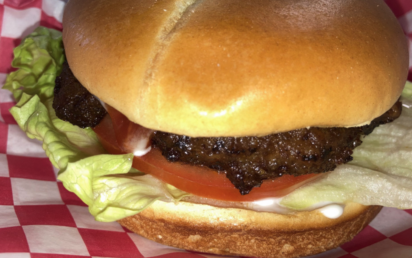 a hamburger with lettuce and tomato