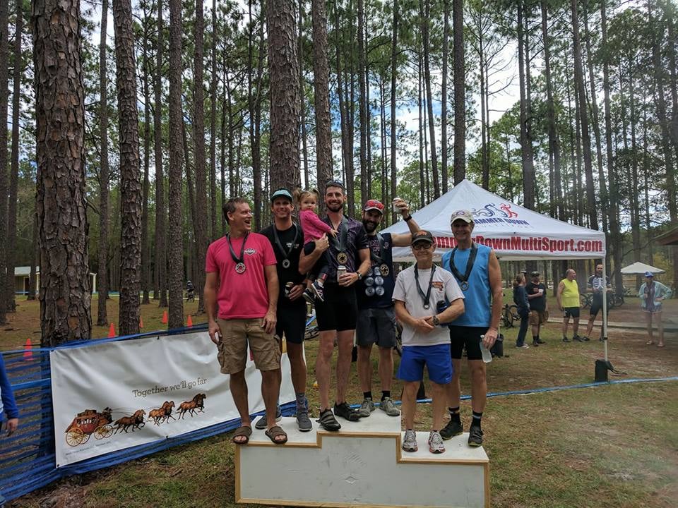People in a state forest standing on an award platform