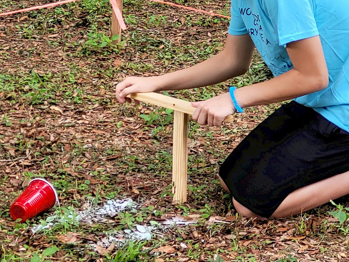 child participating in a worm fiddling competition
