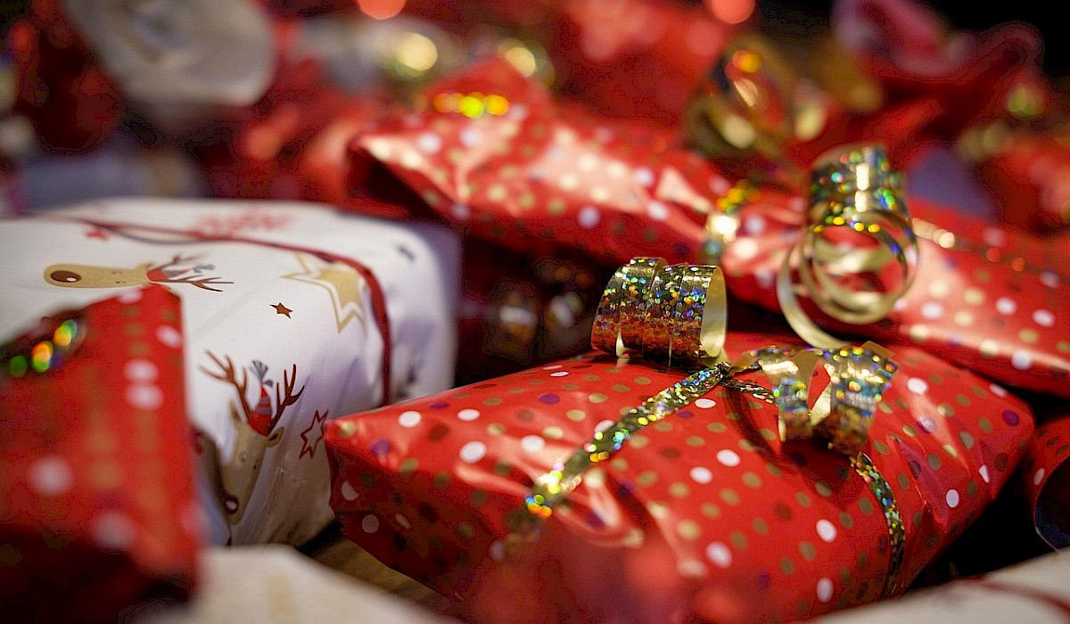 christmas gifts wrapped and under a christmas tree
