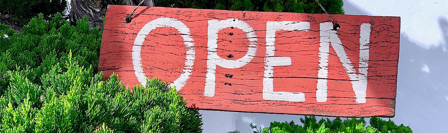 a photo of an old faded wooden open sign